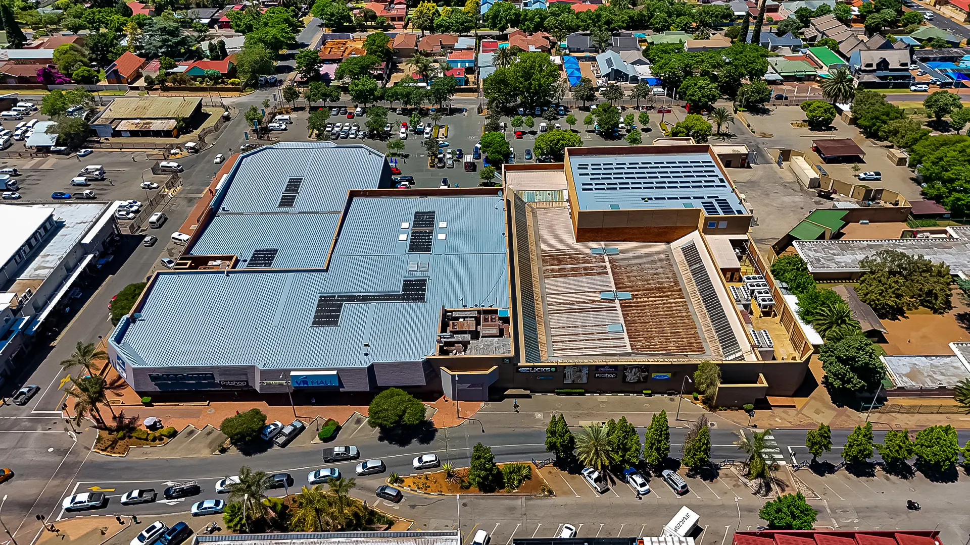 Large retail building roofs and parking in an urban setting, requiring specialized retail building waterproofing & leak repair.
