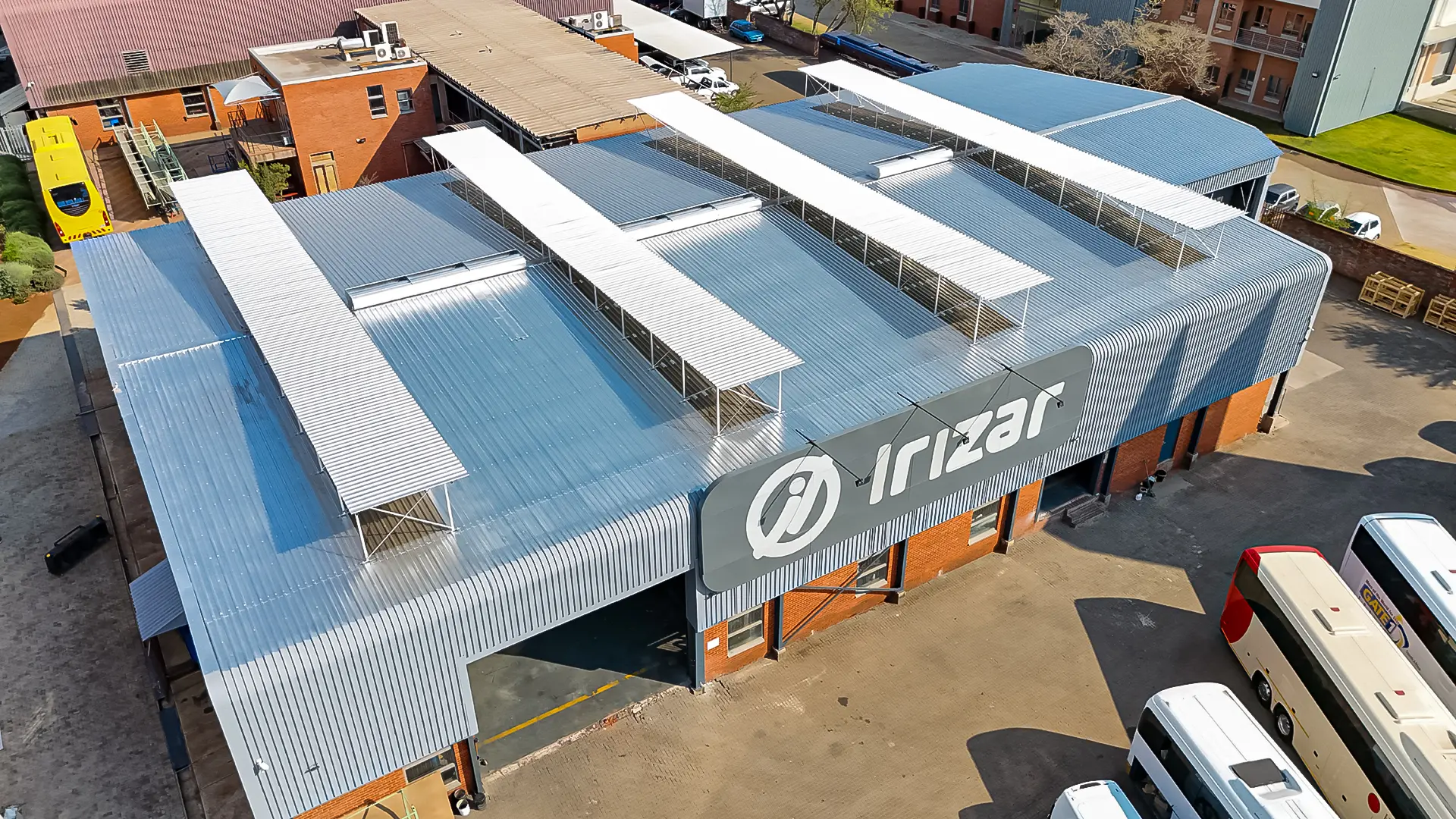 Aerial view of a large Irizar logistics facility, highlighting its vast corrugated roof, perfect for effective roof waterproofing.